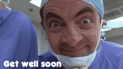 Mr Bean Is Wearing A Surgical Mask And A Surgical Gown And Says Get Well Soon GIF