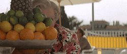 Mrs Doubtfire Peeking Behind Fruits GIF