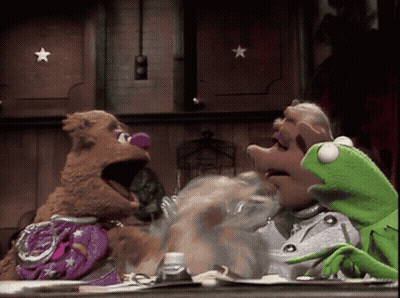 Mrs. Piggy And Kermit Sitting At Table GIF