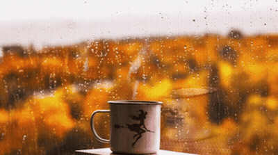 Mug With Witch In Front Of Rainy Window GIF