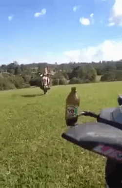 Mullet Haired Guy Doing Motorcycle Tricks GIF