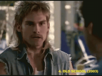 Mullet Man Talking To Another In Old School Movie GIF