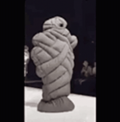 Mummy Statue Wrapped in Blanket Sitting on Table