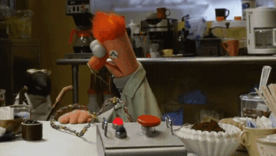 Muppet Sitting At Table With Red Button GIF