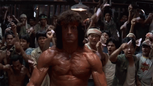 Muscular Man Holding Papers In Front Of Crowd GIF