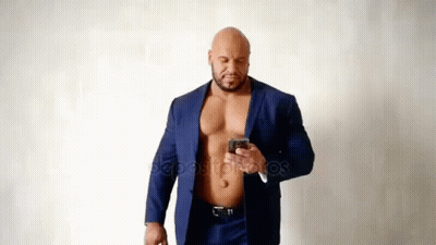 Muscular Man In Suit Without Shirt Using Cell Phone GIF