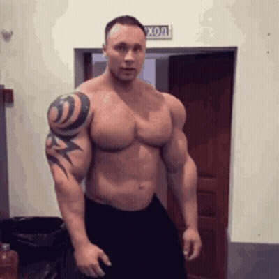 Muscular Man With Tattoo Standing GIF