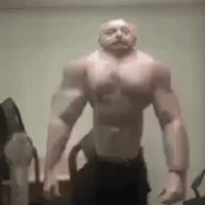 Muscular Man Without Shirt Standing In Room GIF