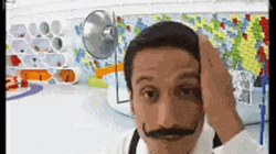 Mustached Man Grooming In Mirror GIF