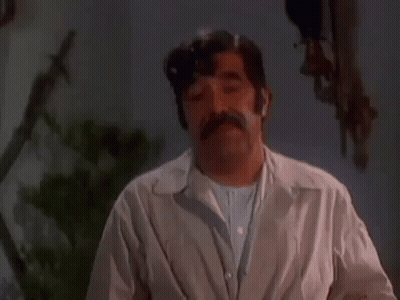 Mustached Man Making Funny Face Dark Room GIF