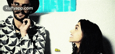 Mustached Man Next to Smiling Woman Saying No
