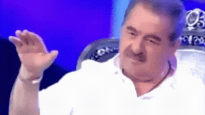 Mustached Man Sitting In Chair Hand Outstretched GIF