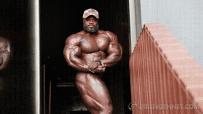 Naked Bodybuilder By Brick Wall GIF