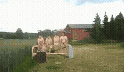 Naked Men Sitting On Bench In Field Near Lake GIF