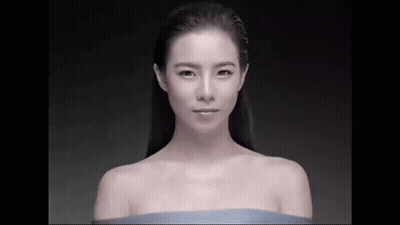 Naked Woman In Blue Cloth Looking At Camera GIF