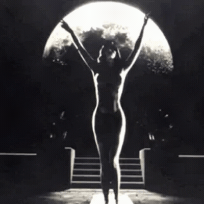 Naked Woman Standing In Front Of Full Moon GIF