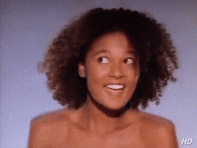 Naked Woman With Curly Hair Smiling GIF