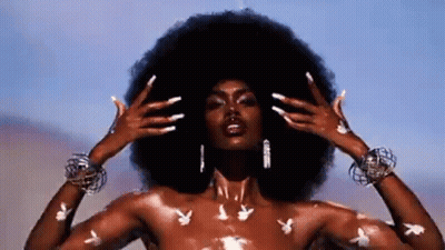 Naked Woman With Large Afro And Playboy Bunny Tattoos GIF