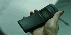 Neo Holding A Phone In Matrix GIF