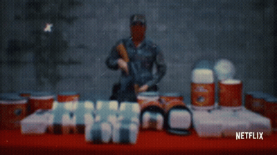 Netflix Ad Man With Gun And Cans GIF