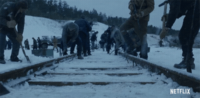 Netflix Ad People Working On Train Tracks In Snow GIF