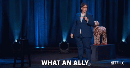 Netflix Ad Woman In Blue Suit Next To Stuffed Animal GIF