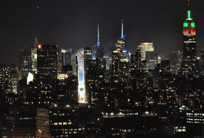 New York City Skyline At Night With The Empire State Building Lit Up GIF