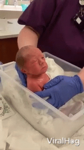 Newborn Baby Held By Nurse GIF
