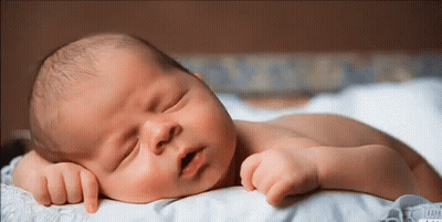 Newborn Baby Sleeping On White Blanket GIF