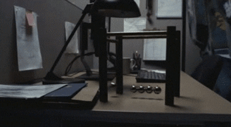 Newton Pendulum On Office Desk GIF