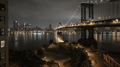 Night Bridge Over Water With City GIF