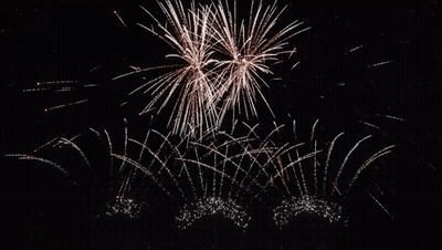 Night Sky Fireworks With Sun Shining GIF