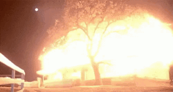 Nighttime Bomb Explosion Illuminating The Sky GIF