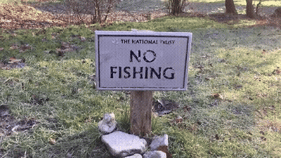 No Fishing Sign In Grass GIF