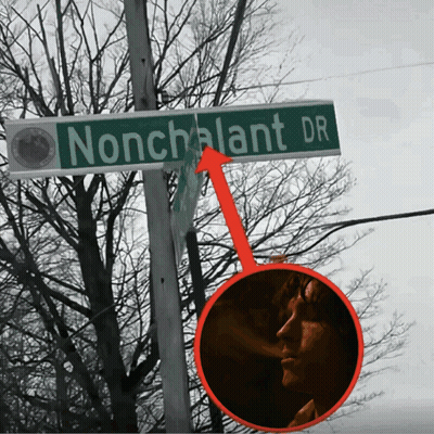 Nonchalant Dr Street Sign With Man Smoking GIF