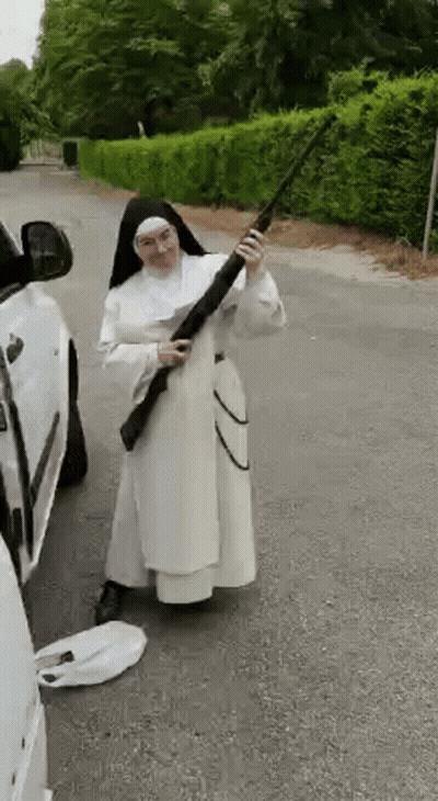 Nun Holding Shotgun Near Car On Roadside GIF
