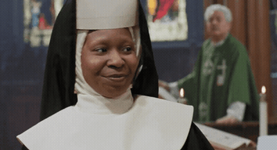 Nun Smiling In Front Of Priest GIF