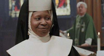 Nun Smiling In Front Of Priest GIF