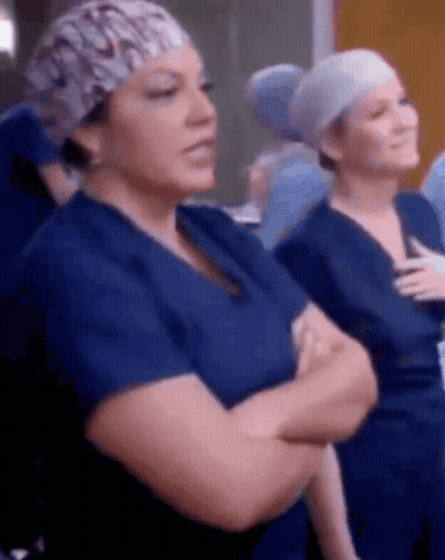 Nurses Standing With Arms Crossed In Scrubs GIF