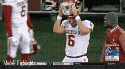 Oklahoma Sooners Football Player Holding Helmet Over Head GIF