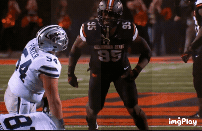 Oklahoma State Football Player Standing On Field GIF