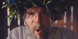 Old Man Blow Sand To Camera GIF