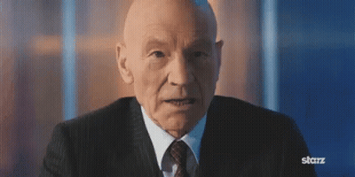 Older Bald Man In Suit And Tie Looking At Camera GIF