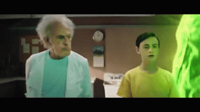 Older Man In Lab Coat Next To Boy In Yellow GIF
