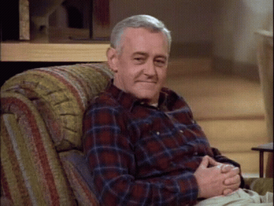 Older Man In Plaid Shirt Sitting In Chair GIF