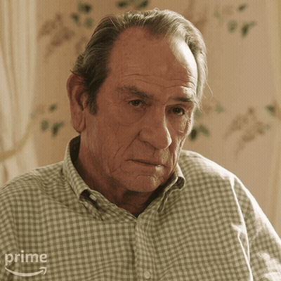 Older Man In Plaid Shirt Sitting In Front Of Prime Logo GIF
