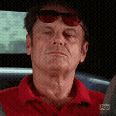 Older Man In Red Shirt Sitting In Car GIF