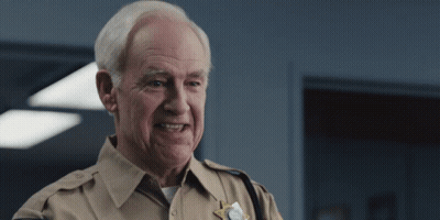 Older Man In Sheriff Uniform Smiling GIF