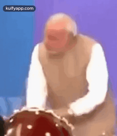 Older Man Playing Drum In Blurry Photo GIF