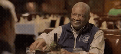 Older Man Sitting At Table With Wine And Water GIF